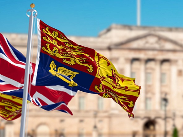 Buckingham Palace with Royal Standard and Union Jack in the foreground